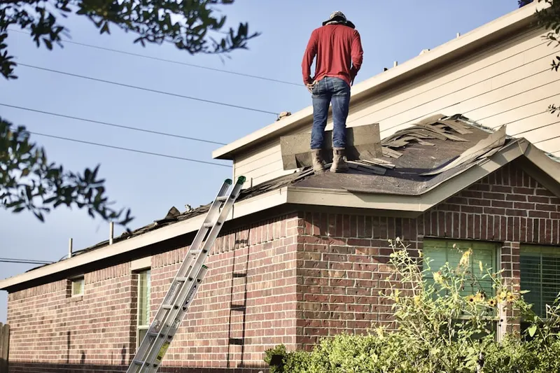 Professional roofer working on a residential roof in Tyndall Village